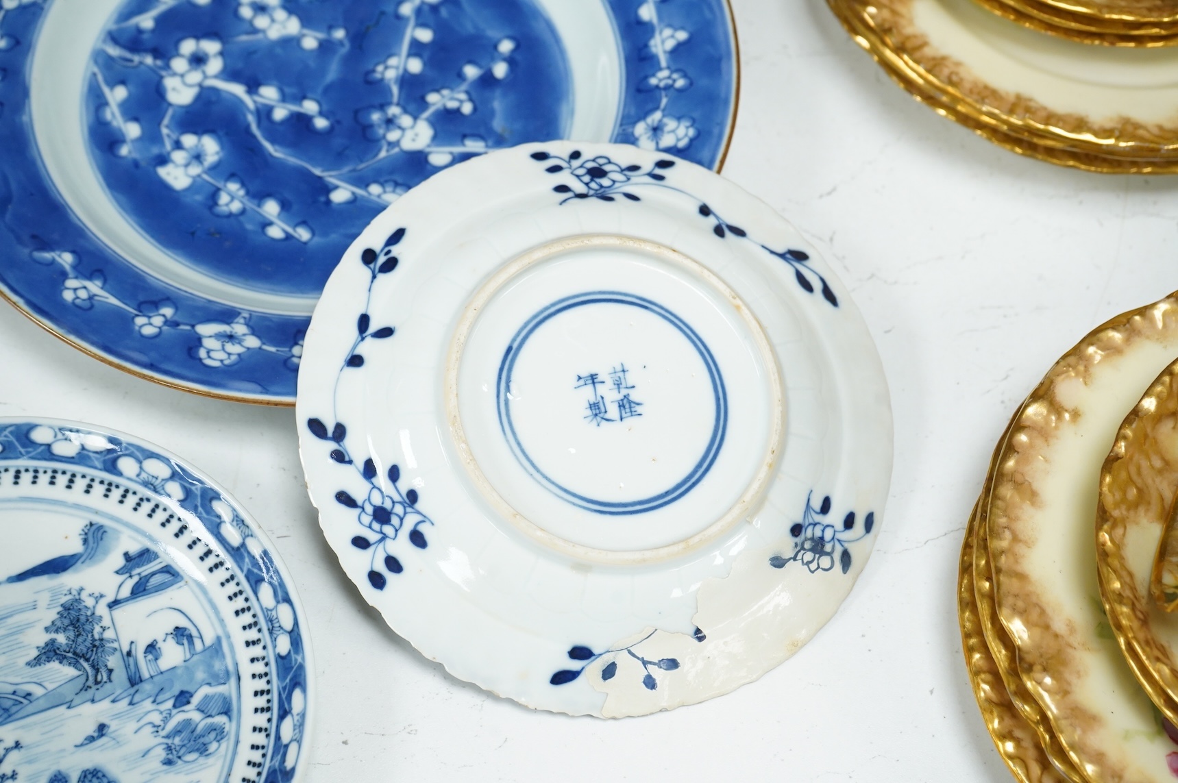 A 19th century Chinese blue landscape plate another smaller, prunus plate, another with restored rim, largest 22.5cm diameter.